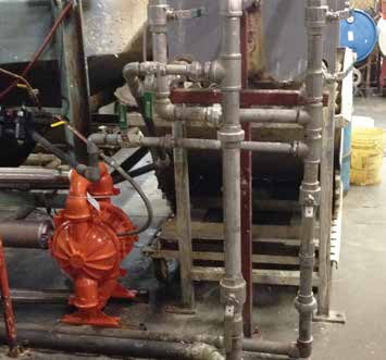 Wilden diaphragm pump installed among pipework in the AMTROL application